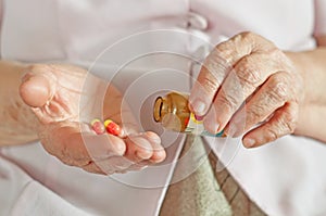 Elderly woman with medicine in a hand
