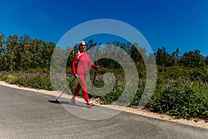 An elderly woman with Nordic walking sticks