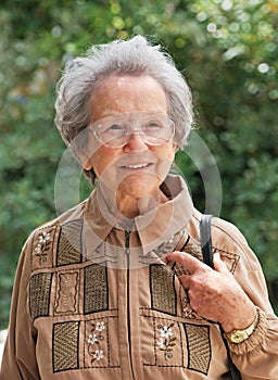 Elderly Woman Out Walking On Sunny Day