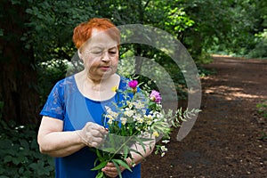 Elderly woman park flowers hands bouquet