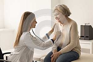 Elderly woman passes health check up during visit in clinic