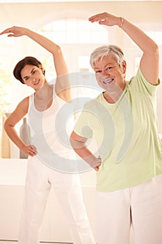 Elderly woman with personal fitness trainer