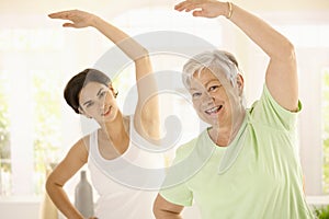 Elderly woman with personal fitness trainer