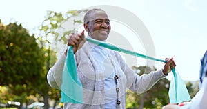 Elderly, woman and physiotherapy for fitness with resistance band in park, outside or garden for wellness. Black person