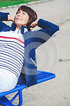 Elderly woman playing sports in street simulator