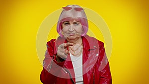 Elderly woman pointing at her eyes and camera, show I am watching you gesture, spying on someone