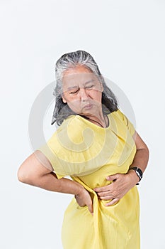 Elderly woman pose in a painful on her body