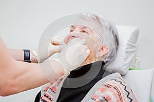 He elderly woman on prosthetics of a teeth