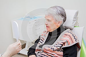 He elderly woman on prosthetics of a teeth