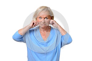 Elderly woman pulling at the skin on her jowls