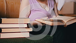 Elderly Woman Reading a Book in the Rays of Sunlight Indoor. 4K. Close-up