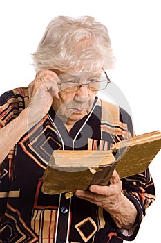 Elderly woman reads the book