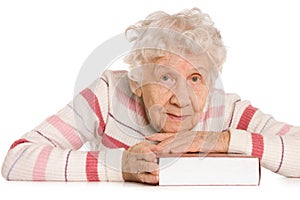 The elderly woman reads the book