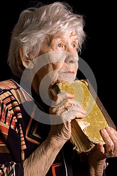 Elderly woman reads the book photo