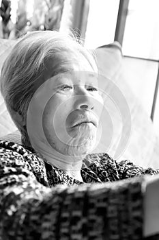 Elderly woman reclining on the nursing bed, close-up portrait