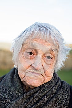 Elderly woman with resignation expression