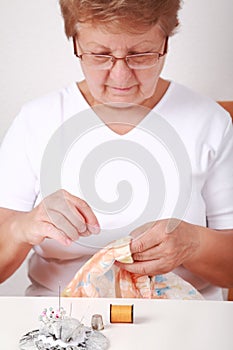 Elderly woman sewing