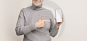 Elderly Woman Showing Blank Smartphone Screen and Pointing On It