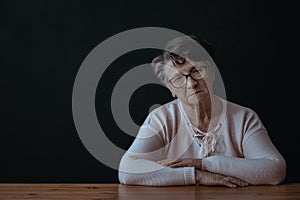 Elderly woman sitting alone