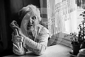 Elderly woman sitting in her home.