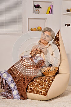 Elderly woman sitting with knitting
