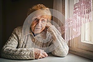 Elderly woman sitting at a loss.