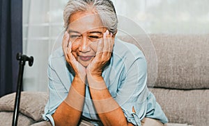 Elderly woman sitting on the sofa happy in her home