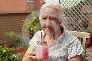 Elderly woman with smoothie