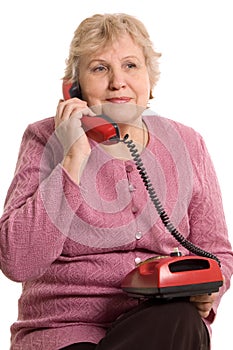 The elderly woman speaks on the phone