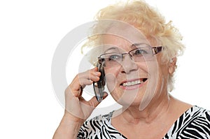 The elderly woman speaks on phone