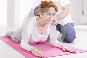 Elderly woman and spine stretching