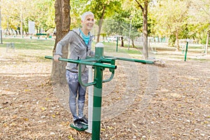 Elderly Woman Exercising At Public Sports Park