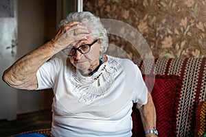Elderly woman in a state of worry at home