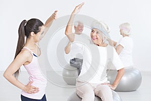 Elderly woman stretching properly photo