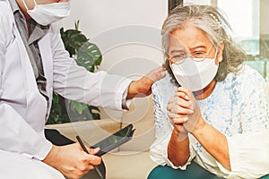 An elderly woman suffering from mental illness and stress sits in therapy and seeks advice from a psychiatrist to relieve her anxi