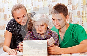 Elderly woman with the sweet young doctors photo
