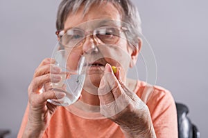 Elderly woman taking medication