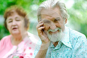 Elderly woman tells a joke to the husband