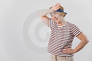 Elderly woman tiredly wipes sweat from her forehead after sports. photo