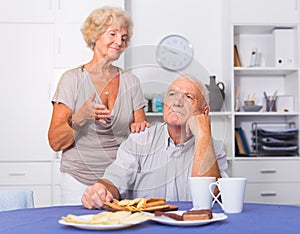 Elderly woman trying to apologize to offended man