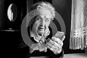 Elderly woman typing on the smartphone. Education.