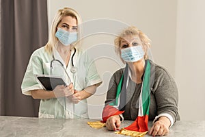 elderly woman with UAE National Flag and nurse