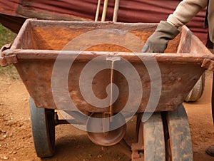 An elderly woman using a rusted cart to transport her meager belongings.. AI generation