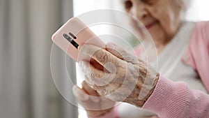 Elderly Woman Using Smartphone Reading Internet News