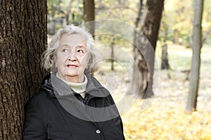 Elderly woman on a walk in autumn park