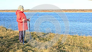 Elderly woman on a walk. Nordic walking