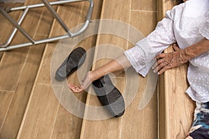 Elderly woman with walker falling down stair