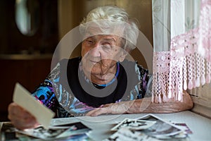 An elderly woman watching photos.