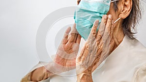 Elderly woman wearing a mask to protect from coronavirus covid-19