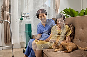 Elderly woman wearing oxygen nasal cannula at home